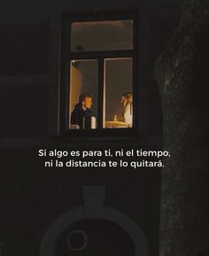 two people are looking out the window at each other in the dark, one person is standing outside