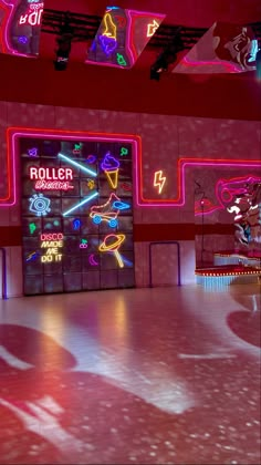 an empty room with neon signs and lights on the walls, as well as flooring