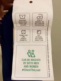 a person holding up a paper sign with instructions on how to wash clothes in the bathroom