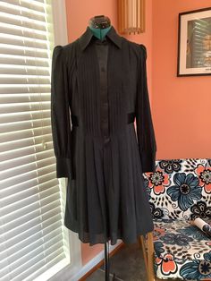 Beautiful Long Sleeve Silk Dress Made by Laundry by Design Tuxedo front buttons  Collared Satin button front strip and waist belt attached Pleated skirt 4" Cuffs Completely lined Knee length  Size 8 Shoulders -15 1/2" Sleeves -25" Bust -38 1/2" Waist -34" Hip - Free Length - 37 1/2" Excellent vintage condition, Beautiful No damages Semi-formal Long Sleeve Fitted Shirt Dress, Fitted Long Sleeve Shirt Dress For Semi-formal Occasions, Fitted Shirt Dress With Button Cuffs For Work, Fitted Knee-length Shirt Dress With Button Cuffs, Fitted Shirt Dress With Button Closure For Work, Fitted Long Sleeve Shirt Dress For Work, Fitted Long Sleeve Belted Shirt Dress, Fitted Button-up Shirt Dress For Work, Semi-formal Fitted Shirt Dress With Button Cuffs