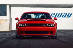 the front end of a red sports car