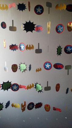 the wall is decorated with various superhero symbols