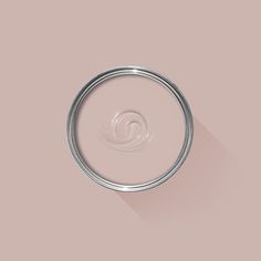 a close up of a paint can on a pink background with a shadow in the middle