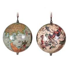 two decorative globes hanging from hooks against a white background