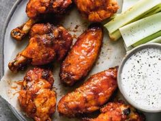 chicken wings and celery on a plate with ranch dressing