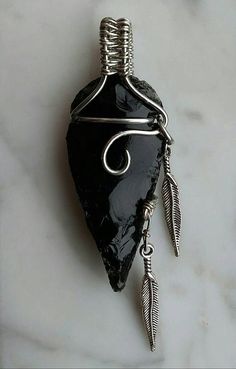 a black stone with silver wire hanging from it