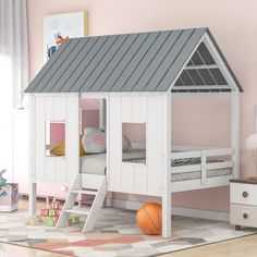 a child's bedroom with a loft bed and pink walls