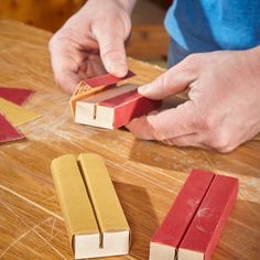 a person is making wooden blocks on a table