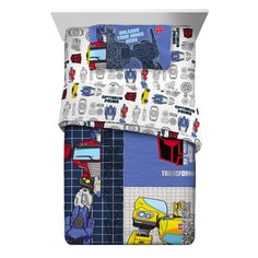 a bed set with cars and trucks printed on the sheets, along with matching pillow cases