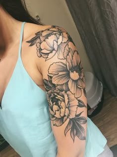 a woman's arm with flowers on it