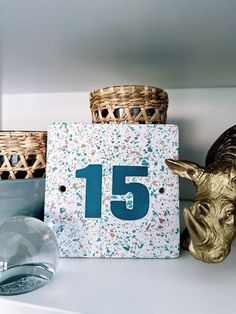 a wooden sign with the number fifteen on it next to some baskets and other items