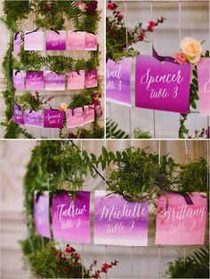 wedding seating signs hanging from the ceiling and decorated with greenery, flowers, and ribbons