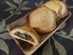 two pastries sitting on top of a wooden plate