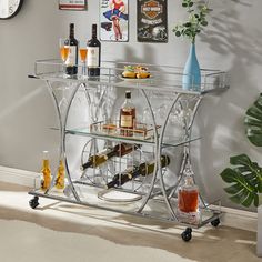 a bar cart with bottles and glasses on it