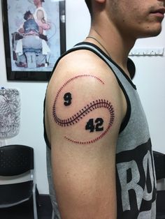 a man with a baseball tattoo on his arm