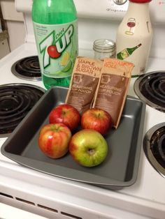 apples, chocolate bars and water are on the stove