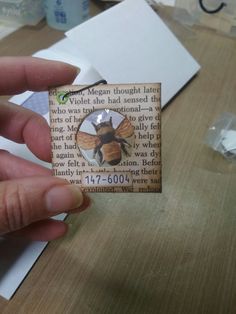 a person holding a piece of paper with a bee on it