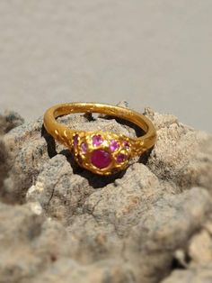 This is a goldfilled designer delicate  handmade ring which has a simple  minimalist design. The ring is set with 22-25 rubies gems.-Listing is for one ring-14 karat goldfilled -22-25 rubies -Free shipping worldwide-All my jewelry come in a gift boxI can also make this ring with your favorite gemstone or birthstone, choose from: blue topaz, garnet and smoky quartz. I can make this ring in silver, goldfilled for the same price, or solid gold by request.If you have another gem in your mind let me Handmade Yellow Gold Ruby Promise Ring, Wedding Stackable Ruby Rings In Gold, Dainty Ruby Ring As Birthstone, Dainty Ruby Birthstone Ring, 22k Gold Ruby Ring Gemstone For Gift, 22k Gold Ruby Gemstone Ring As Gift, Elegant 22k Gold Ruby Ring Gift, Dainty Gold Ruby Ring With Gemstones, Dainty Gold Ruby Ring For Wedding