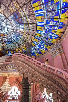 the inside of a building with colorful stained glass windows and decorative ceiling tiles on it