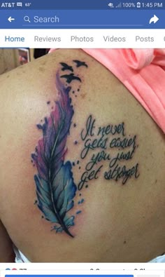 the back of a woman's shoulder with a tattoo on it that says,