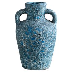 a large blue vase with holes in the middle of it's body, on a white background