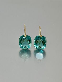 Beautiful Paraiba tourmaline earrings in Brilliant drops. The faceted rectangle drops have a gorgeous ocean blue color that brings lots of depth to the stone and reflects light beautifully. The fancy drops are attached to 24K Gold Vermeil/14K SOLID GOLD ear wires. The earrings are elegant, and minimalist, and have a lux look.  A truly gorgeous pair of earrings When 14K SOLID GOLD ear wires are being used, the ear wire ends are hand-stamped as proof of being 14K solid gold. In addition, extra wor Ocean Blue Color, Extra Work, Indicolite Tourmaline, Tourmaline Earrings, Paraiba Tourmaline, Tourmaline Jewelry, Blue Tourmaline, Types Of Gemstones, Ocean Blue