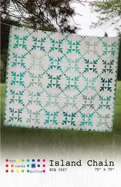 the island chain quilt pattern is displayed in front of a green field with trees and grass