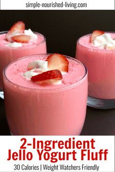 three desserts with strawberries and whipped cream on top sit in small glasses, ready to be eaten