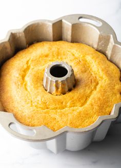 a bundt cake in a pan with a hole in the middle on a table