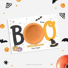 an orange plate with the word boo on it next to pumpkins and bats in the background