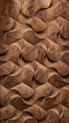 a close up view of a wall made out of brown clay with wavy shapes on it