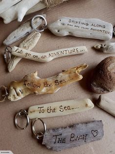 several different types of keychains and other items on a table with words written on them