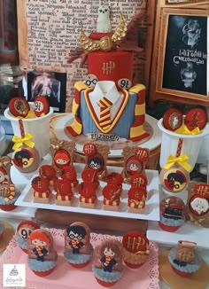 a table topped with lots of cupcakes and cakes