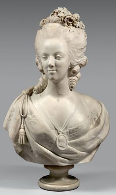 a statue of a woman wearing a tiara and holding a flower in her hair