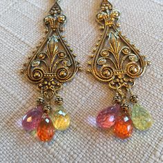 Beautiful Brass Floral Finding Earrings With Three Color Briolette Pendants. Three Color Micro Faceted Corundum Pendants, Pink, Orange, Yellow. Small Brass Beads. Vintage Brass Leverback Closure.    Size  :       3 1/4    inches                          (8.5cm) Elegant Multicolor Filigree Jewelry, Elegant Jeweled Earrings, Bohemian Jeweled Drop Earrings, Bohemian Jeweled Chandelier Earrings As Gift, Bohemian Jeweled Gold Earrings, Bohemian Gold Jeweled Earrings, Bohemian Teardrop Jeweled Jewelry, Jeweled Earrings As Gift, Pretty Accessories