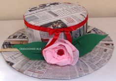 a paper hat with a pink flower on it