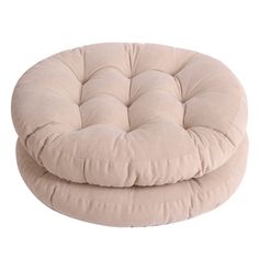 a round chair that is sitting on top of a white floor mat and has a beige cover over it