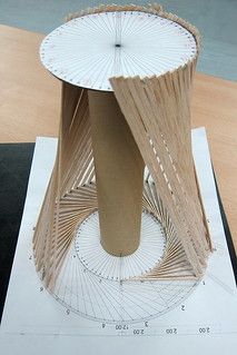 a paper model of a tall wooden structure on top of a piece of white paper