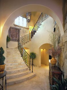 an image of a house with stairs and potted plants