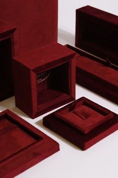 several different types of red velvet jewelry boxes