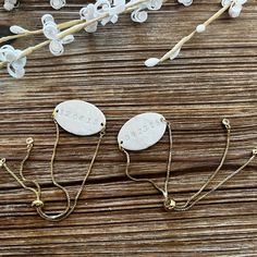 three personalized necklaces on a wooden table