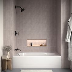 a white bath tub sitting next to a wooden stool in a bathroom on top of a gray floor