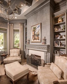 a living room with couches, chairs and a fireplace