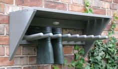 a brick wall with some metal pipes attached to it