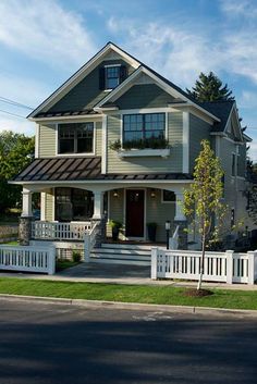 a two story house with a white picket fence