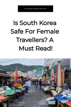 an outdoor market with tables and umbrellas in the background text reads is south korea safe for female travelers? a must read