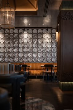 the interior of a restaurant with many plates on the wall