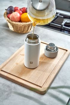 a person pours wine into a glass on a cutting board