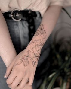 a woman's arm with flowers on it