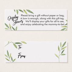 two white gift tags with green leaves on them